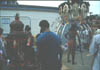 A devotee pulling a small chariot hooked to his back in addition to carrying a kavadi
