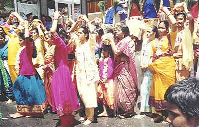 Women devotees carry Pal Kudam in the Taippoosam Kavadi procession