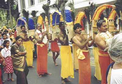 Male devotees carry Pal Kavadi in the annual Kavadi procession